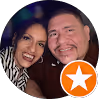 Smiling man and woman posing closely together with an orange star badge overlay.